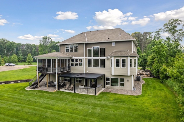 14217 Packard St NE, Ham Lake, MN 55304 - back of house featuring a sunroom, a patio area, stairway, a lawn, and a shingled roof
