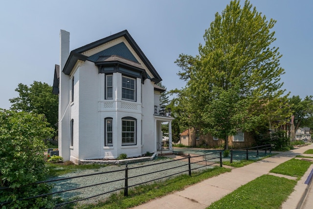 121 Hickory St, Chaska, MN 55318 - view of side of home with brick siding and a chimney