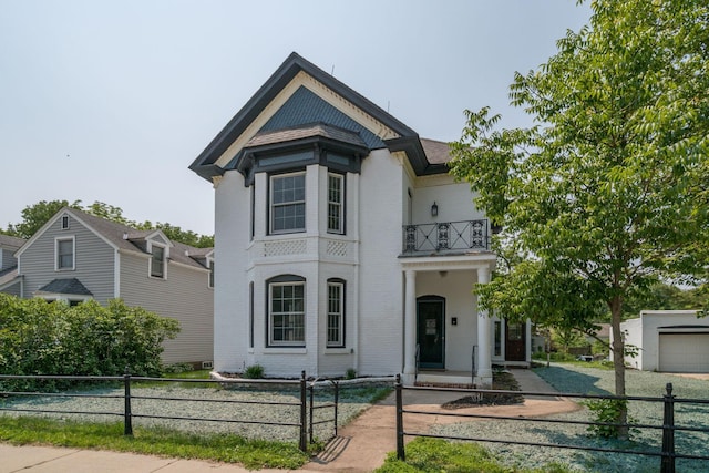 121 Hickory St, Chaska, MN 55318 - view of front of home with a balcony, a fenced front yard, and brick siding