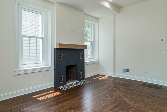 121 Hickory St, Chaska, MN 55318 - unfurnished living room with a brick fireplace and baseboards