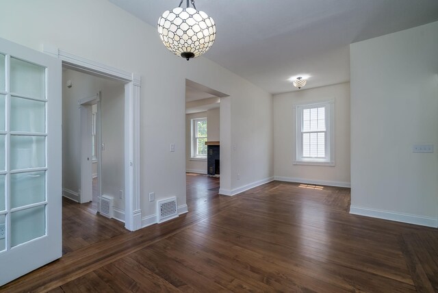 121 Hickory St, Chaska, MN 55318 - empty room featuring dark wood finished floors and a chandelier