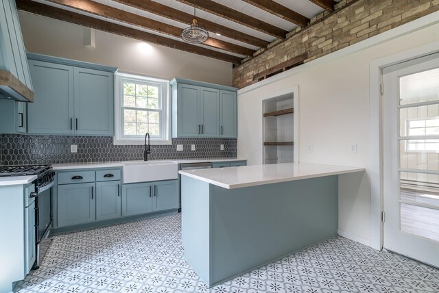 121 Hickory St, Chaska, MN 55318 - kitchen featuring black gas range oven, light countertops, beam ceiling, tasteful backsplash, and blue cabinetry