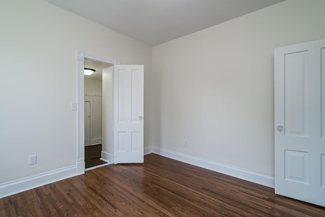 121 Hickory St, Chaska, MN 55318 - unfurnished bedroom with baseboards and dark wood-style flooring