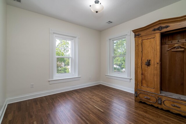 121 Hickory St, Chaska, MN 55318 - unfurnished bedroom featuring baseboards and dark wood-style floors