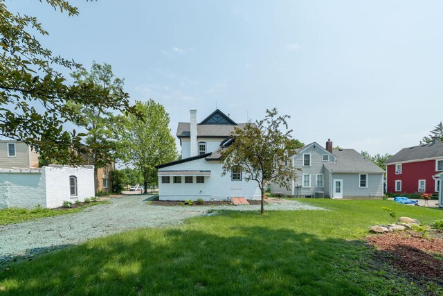 121 Hickory St, Chaska, MN 55318 - back of property with a lawn and a residential view