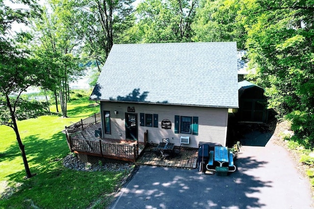 W6741 Lakewood Blvd, Dewey Twp, WI 54848 - view of front facade with a deck, a front yard, and asphalt driveway