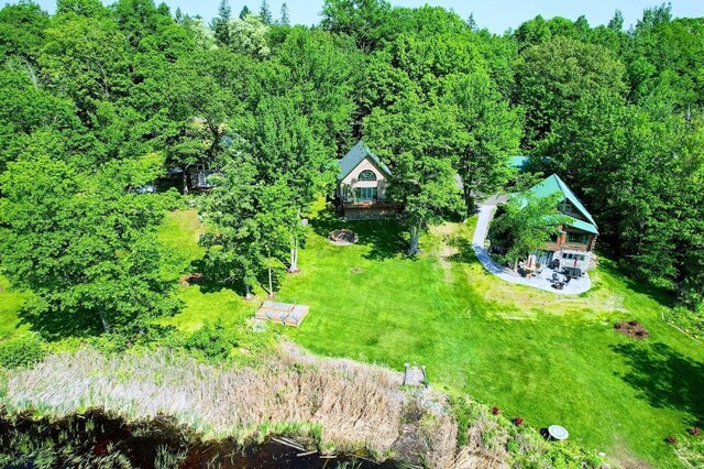 W6741 Lakewood Blvd, Dewey Twp, WI 54848 - aerial view of property and surrounding area with a heavily wooded area
