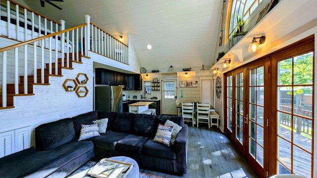 W6741 Lakewood Blvd, Dewey Twp, WI 54848 - living area featuring french doors, plenty of natural light, high vaulted ceiling, and dark wood-style floors