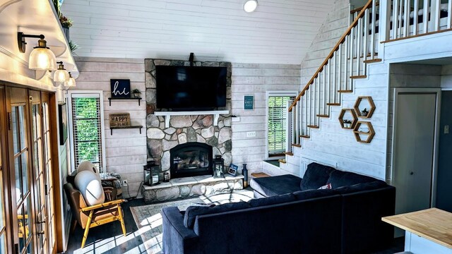 W6741 Lakewood Blvd, Dewey Twp, WI 54848 - living area with a fireplace, stairs, wooden walls, and wood ceiling