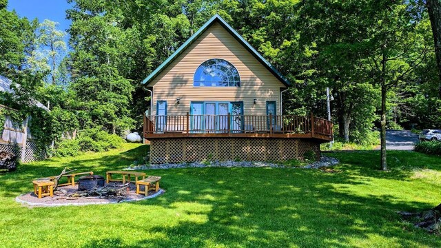 W6741 Lakewood Blvd, Dewey Twp, WI 54848 - back of property with a fire pit, a deck, and a yard