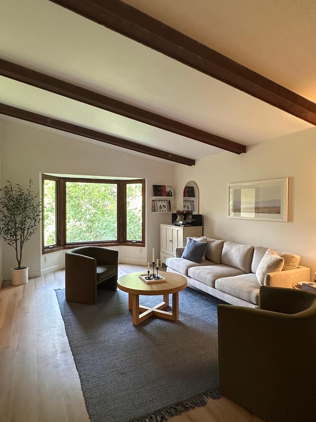 910 Penamint Ct, Chanhassen, MN 55317 - living area featuring beam ceiling, wood finished floors, and arched walkways