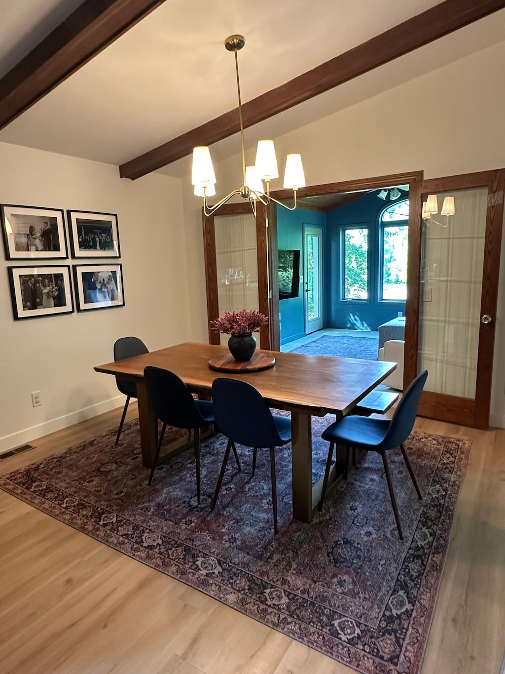 910 Penamint Ct, Chanhassen, MN 55317 - dining area with beam ceiling, a chandelier, and wood finished floors