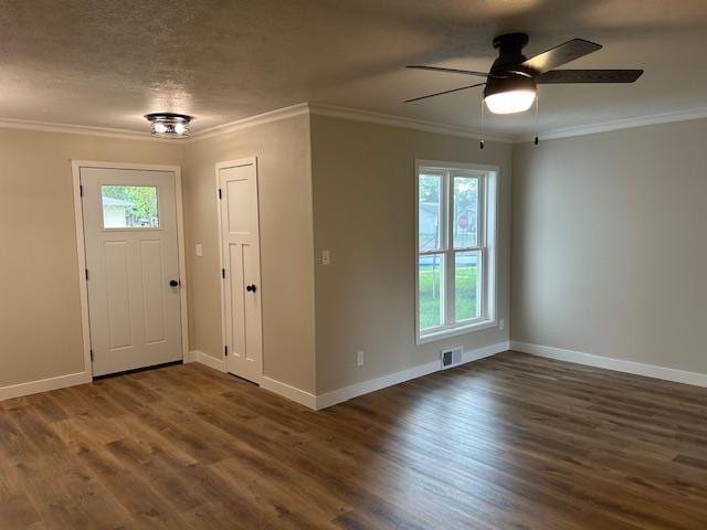 206 3rd St, Minneota, MN 56264 - entryway featuring healthy amount of natural light, dark wood-type flooring, ceiling fan, and crown molding