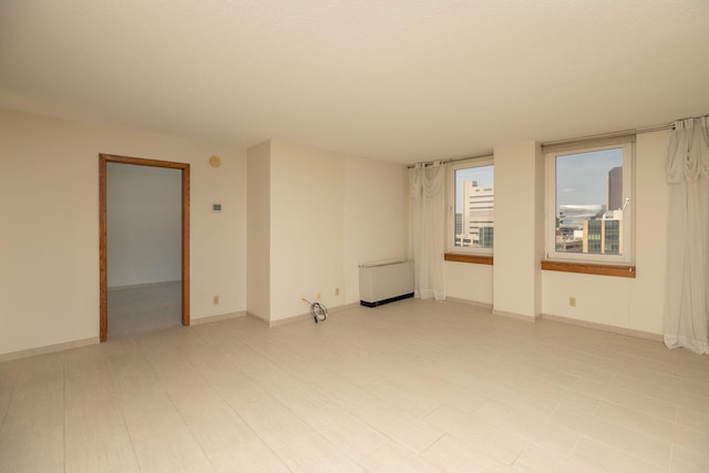 220 Broadway Ave S Unit 1221, Rochester, MN 55904 - spare room with baseboards and radiator