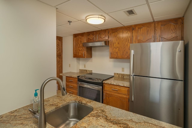 220 Broadway Ave S Unit 1221, Rochester, MN 55904 - kitchen with stainless steel appliances, a paneled ceiling, brown cabinets, under cabinet range hood, and light stone countertops