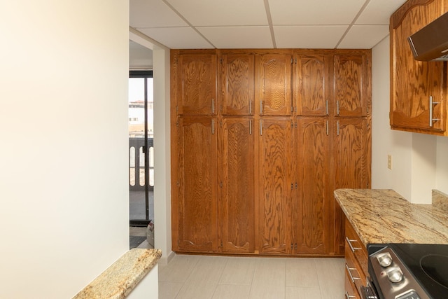 220 Broadway Ave S Unit 1221, Rochester, MN 55904 - kitchen with brown cabinets, wall chimney exhaust hood, stainless steel range with electric stovetop, and a drop ceiling