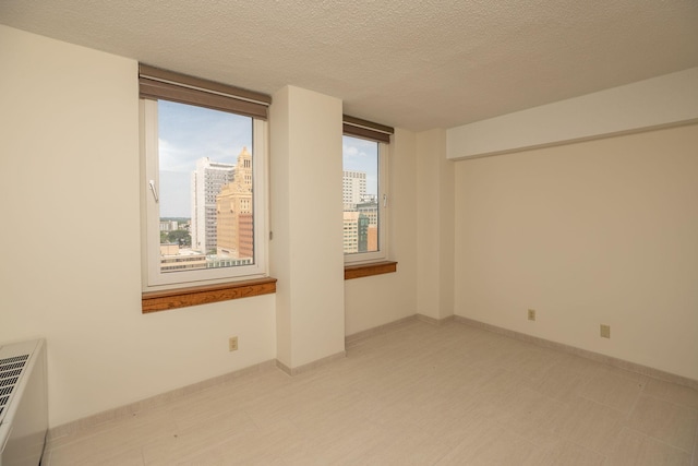 220 Broadway Ave S Unit 1221, Rochester, MN 55904 - empty room with a view of city, a textured ceiling, and light flooring
