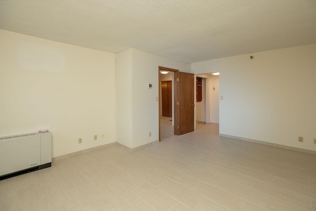 220 Broadway Ave S Unit 1221, Rochester, MN 55904 - empty room featuring heating unit and a textured ceiling