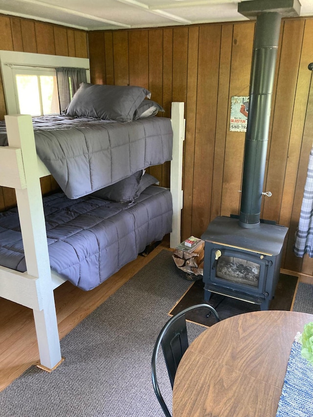 TBD Thompson Forest Rd, Roseau, MN 56751 - bedroom featuring wooden walls and a wood stove