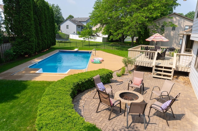 4731 Hazeltine Ln, Eagan, MN 55123 - view of swimming pool featuring an outdoor fire pit, a wooden deck, a patio area, and a residential view