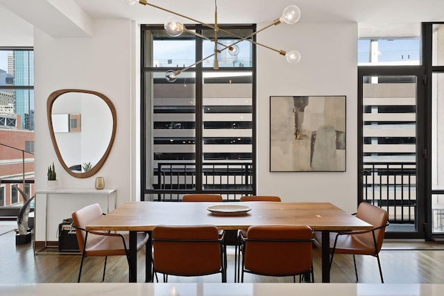 201 11th St Unit 530, Minneapolis, MN 55403 - dining space featuring healthy amount of natural light, wood finished floors, a wall of windows, and a chandelier