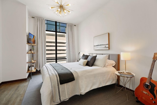 201 11th St Unit 530, Minneapolis, MN 55403 - bedroom featuring a chandelier, wood finished floors, and expansive windows
