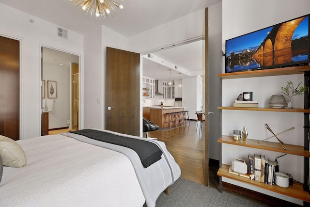 201 11th St Unit 530, Minneapolis, MN 55403 - bedroom with wood finished floors and a chandelier