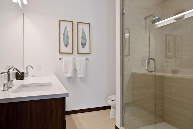 201 11th St Unit 530, Minneapolis, MN 55403 - bathroom featuring double vanity and a stall shower
