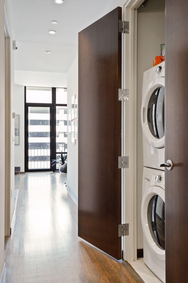 201 11th St Unit 530, Minneapolis, MN 55403 - laundry room featuring stacked washer / drying machine, wood finished floors, and recessed lighting
