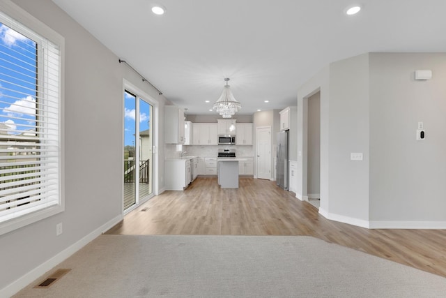 14320 Alder Way, Rosemount, MN 55068 - kitchen with stainless steel appliances, a chandelier, recessed lighting, open floor plan, and tasteful backsplash