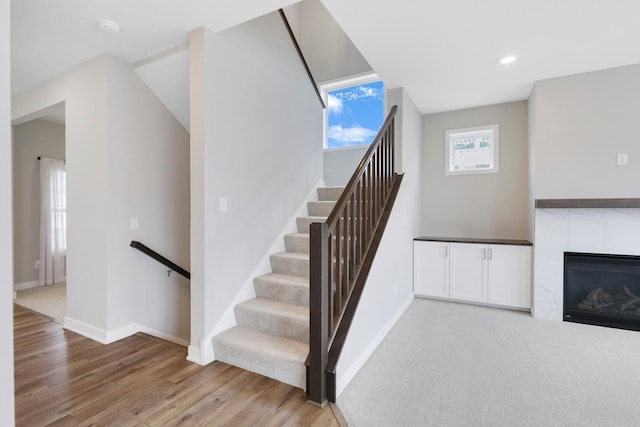 14320 Alder Way, Rosemount, MN 55068 - stairs with wood finished floors, a tiled fireplace, and recessed lighting