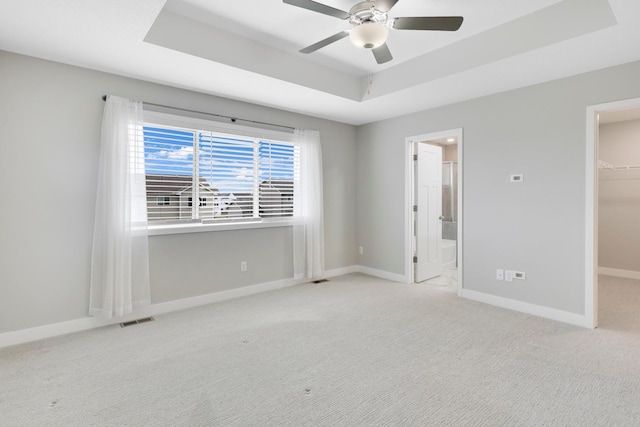 14320 Alder Way, Rosemount, MN 55068 - unfurnished bedroom with a tray ceiling, a spacious closet, carpet floors, a closet, and connected bathroom