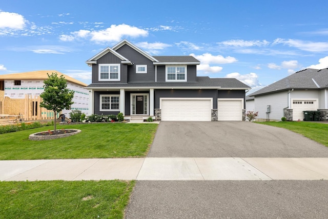 14320 Alder Way, Rosemount, MN 55068 - view of front of property featuring asphalt driveway, a front yard, stone siding, and an attached garage