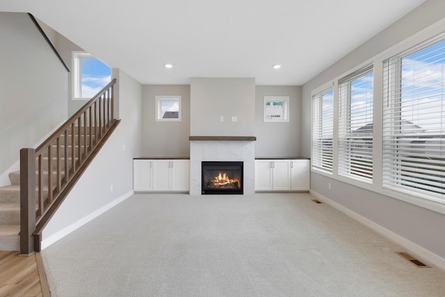 14320 Alder Way, Rosemount, MN 55068 - unfurnished living room with a tile fireplace, stairs, and recessed lighting