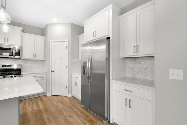 14320 Alder Way, Rosemount, MN 55068 - kitchen featuring stainless steel appliances, light countertops, backsplash, white cabinets, and recessed lighting