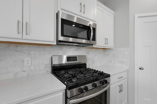 14320 Alder Way, Rosemount, MN 55068 - kitchen featuring stainless steel appliances, white cabinets, and backsplash