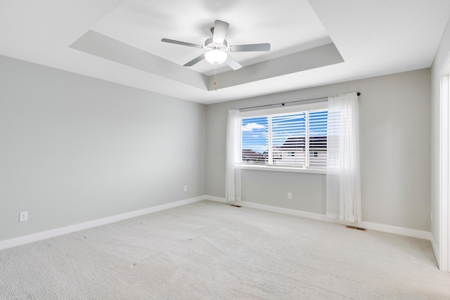 14320 Alder Way, Rosemount, MN 55068 - spare room featuring a raised ceiling, light colored carpet, and a ceiling fan