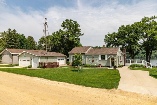 40536 Ryans Bay Rd, Zumbro Twp, MN 55991 - view of front facade with a garage, a chimney, an outbuilding, and a front lawn