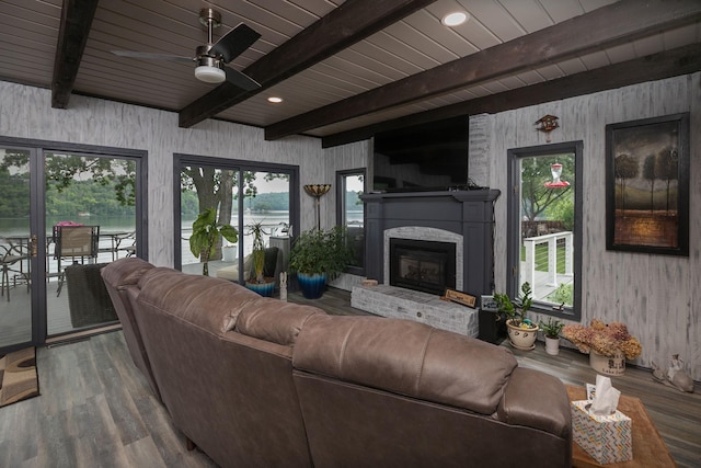 40536 Ryans Bay Rd, Zumbro Twp, MN 55991 - living area featuring wood finished floors, a ceiling fan, a brick fireplace, wood walls, and a wooden ceiling with exposed beams