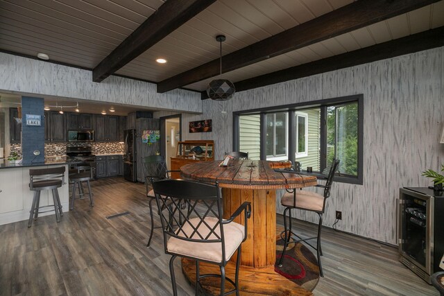 40536 Ryans Bay Rd, Zumbro Twp, MN 55991 - dining space featuring dark wood-style flooring, wine cooler, beamed ceiling, and wallpapered walls