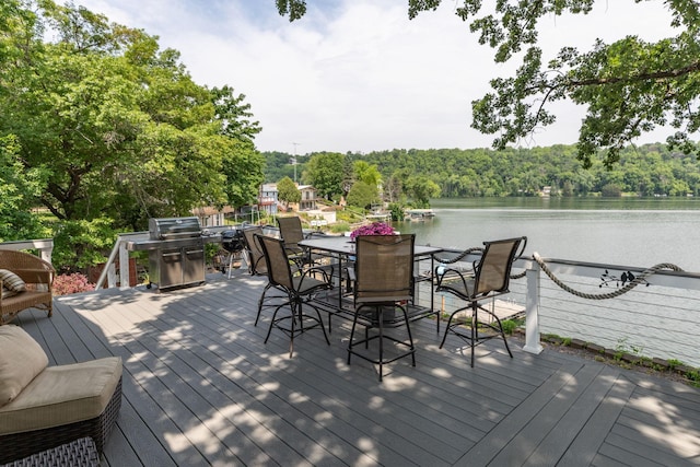 40536 Ryans Bay Rd, Zumbro Twp, MN 55991 - deck featuring a water view, area for grilling, outdoor dining space, and a forest view