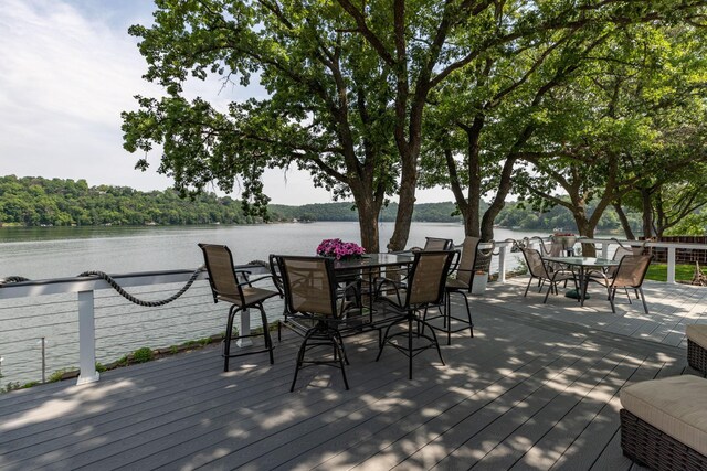 40536 Ryans Bay Rd, Zumbro Twp, MN 55991 - wooden terrace featuring outdoor dining area and a water view