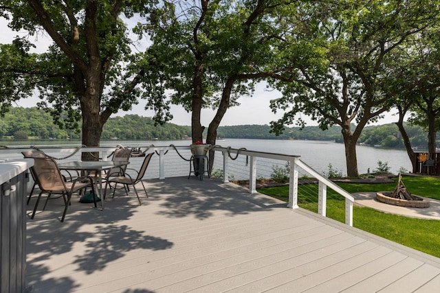 40536 Ryans Bay Rd, Zumbro Twp, MN 55991 - wooden terrace with a water view, a fire pit, and outdoor dining area