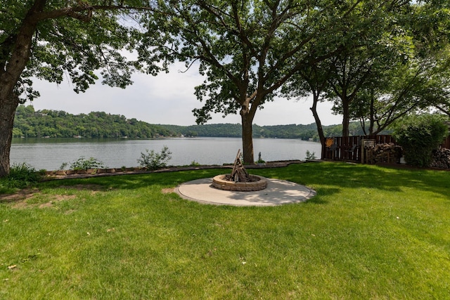 40536 Ryans Bay Rd, Zumbro Twp, MN 55991 - view of grassy yard with a water view, a fire pit, and a wooded view