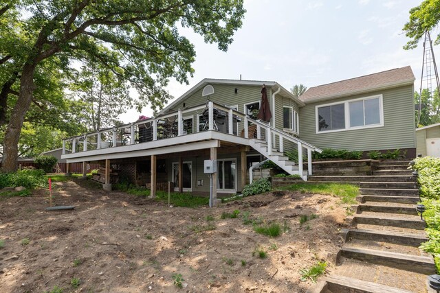 40536 Ryans Bay Rd, Zumbro Twp, MN 55991 - rear view of house featuring stairway and a deck