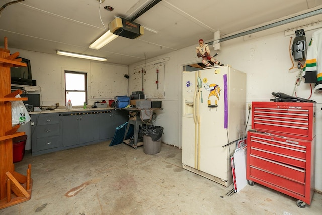 40536 Ryans Bay Rd, Zumbro Twp, MN 55991 - garage with white refrigerator with ice dispenser, a garage door opener, and a workshop area