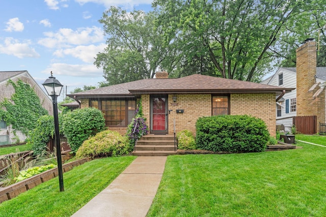 2709 Ewing Ave N, Robbinsdale, MN 55422 - view of front facade featuring brick siding, roof with shingles, and a chimney