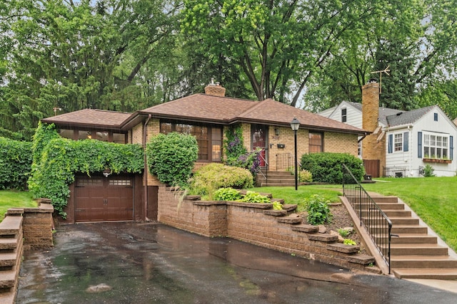 2709 Ewing Ave N, Robbinsdale, MN 55422 - view of front of house featuring asphalt driveway, a front lawn, brick siding, a garage, and a chimney