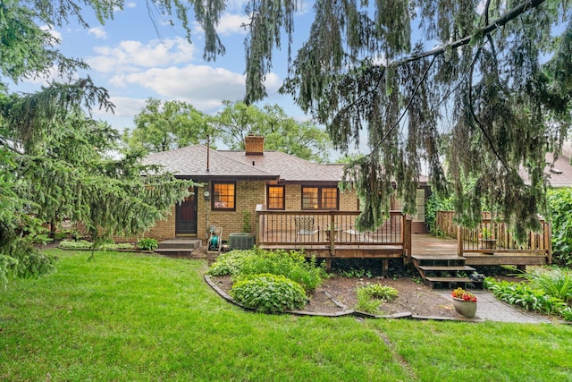 2709 Ewing Ave N, Robbinsdale, MN 55422 - rear view of property with a chimney, brick siding, a yard, a shingled roof, and a deck