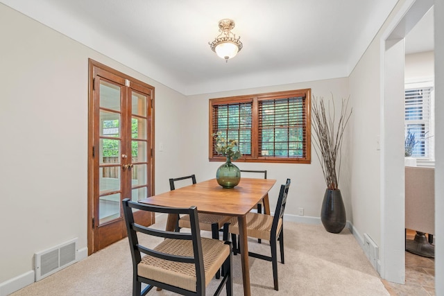 2709 Ewing Ave N, Robbinsdale, MN 55422 - dining area featuring french doors, healthy amount of natural light, and light colored carpet